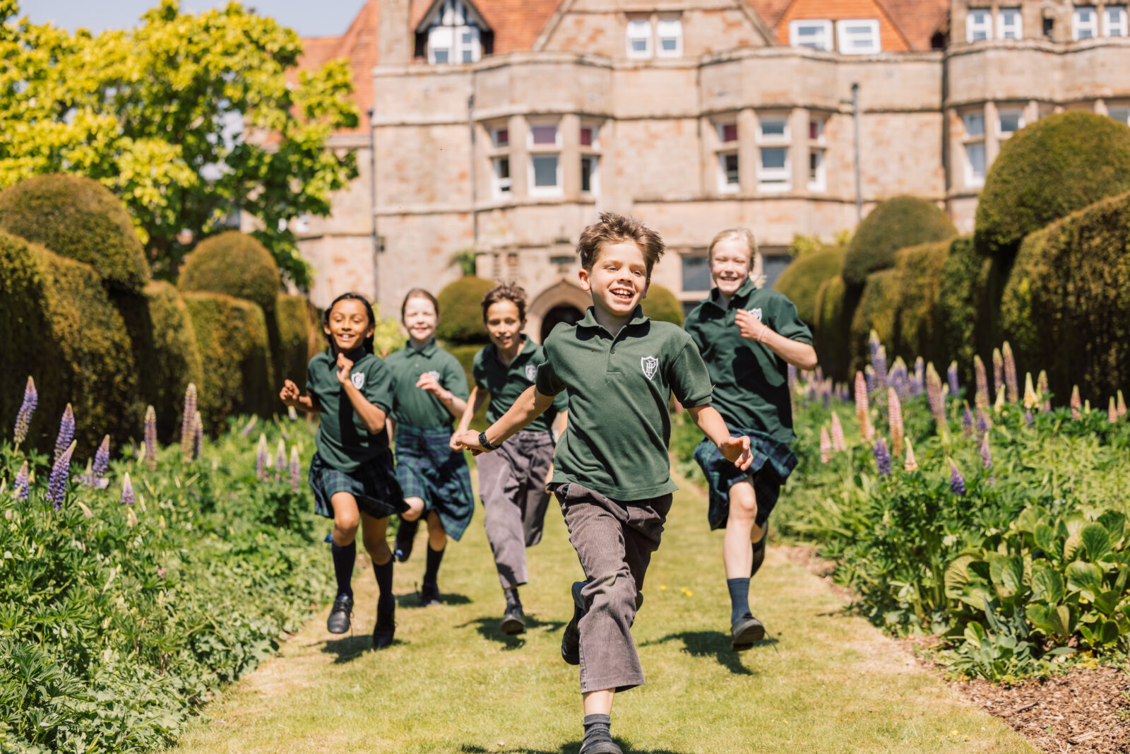 Children happily running through picturesque school grounds