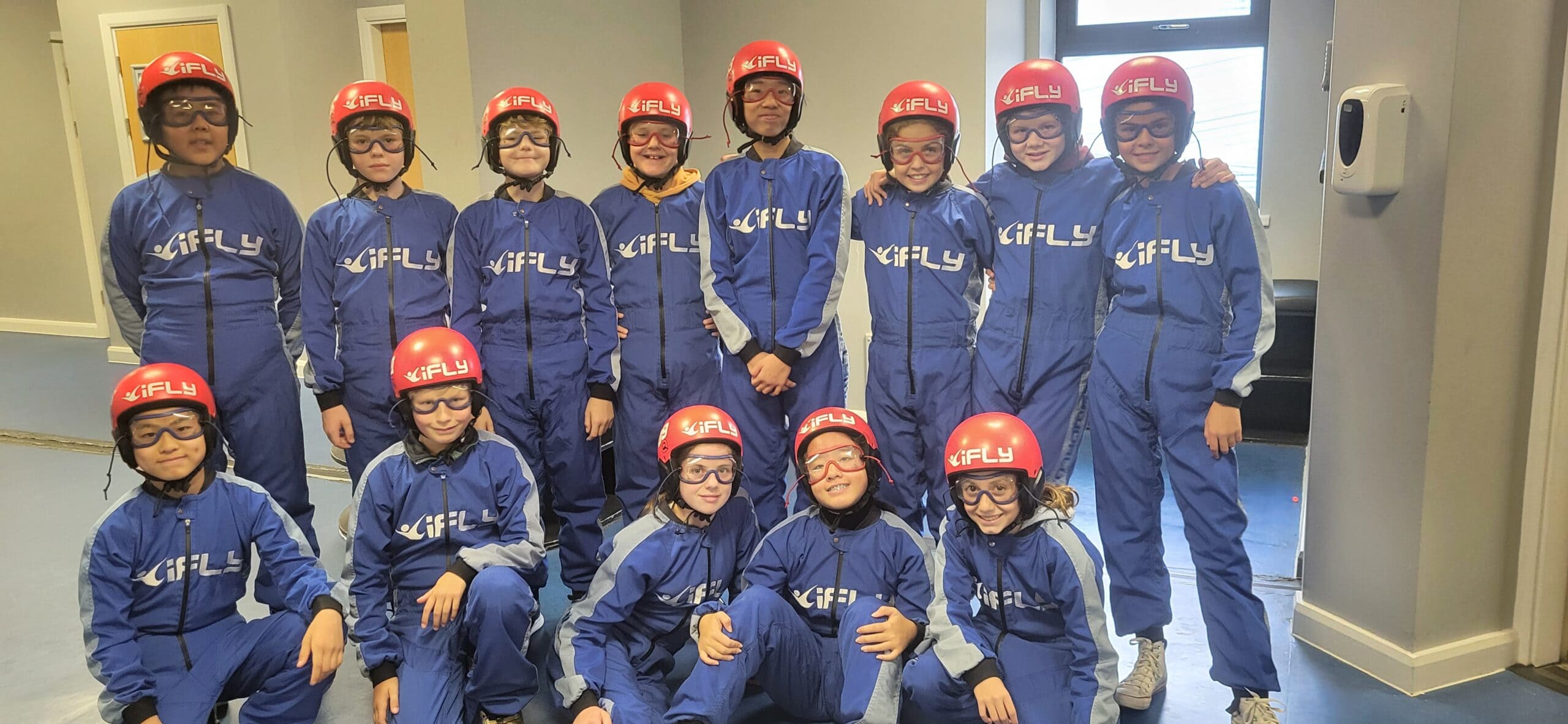 Group of school children ready to participate in indoor skydiving activity