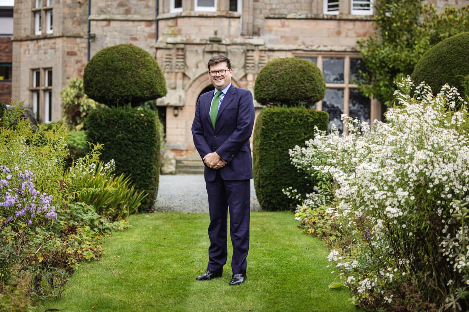 Packwood Headmaster stood on lawn outside main school hall