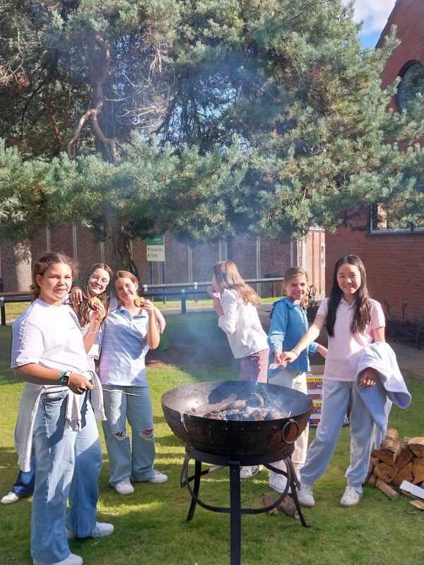 Girls enjoying cooking food on a barbeque