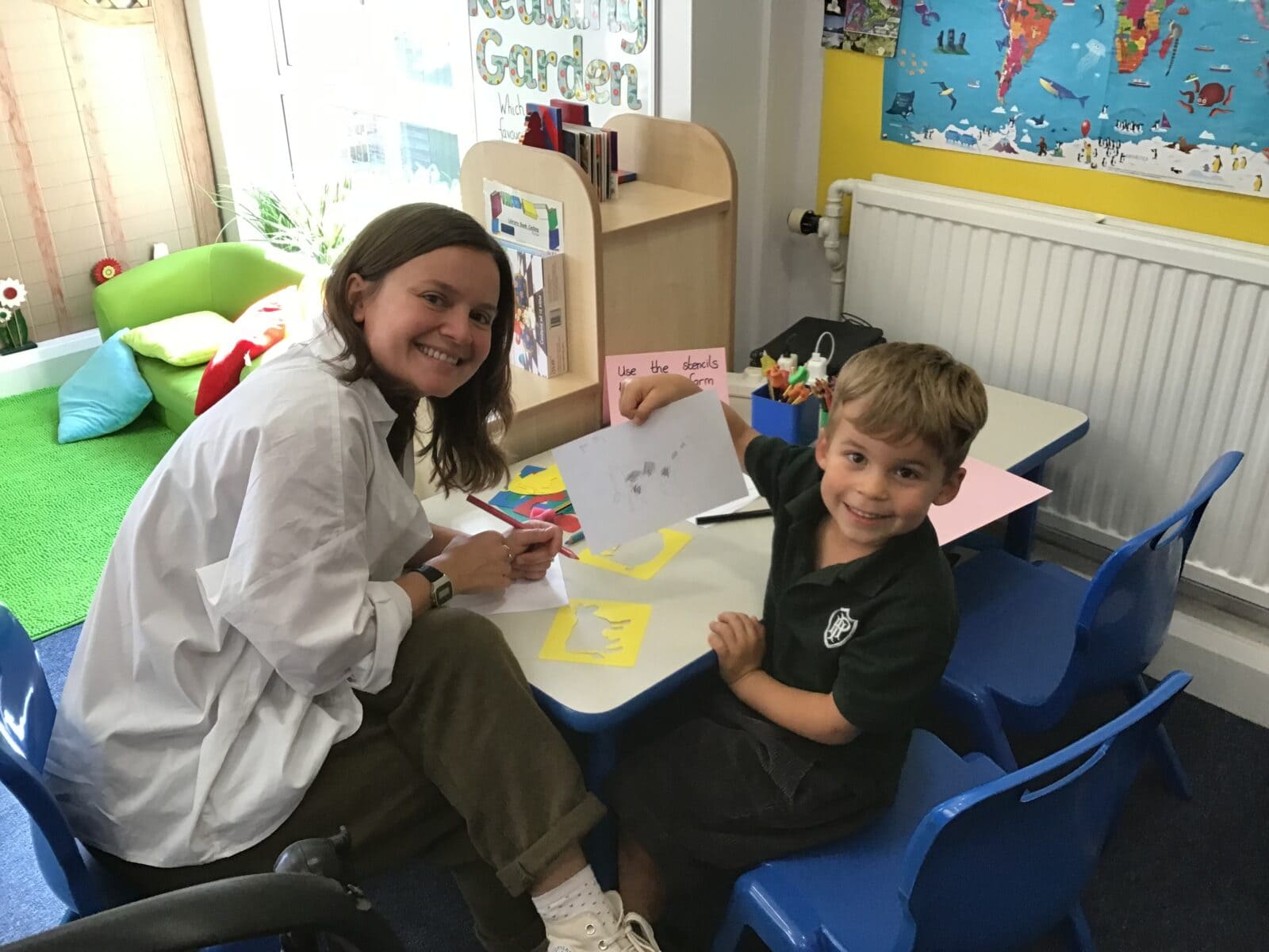 Mother and son doing enjoying art and crafts activities in classroom