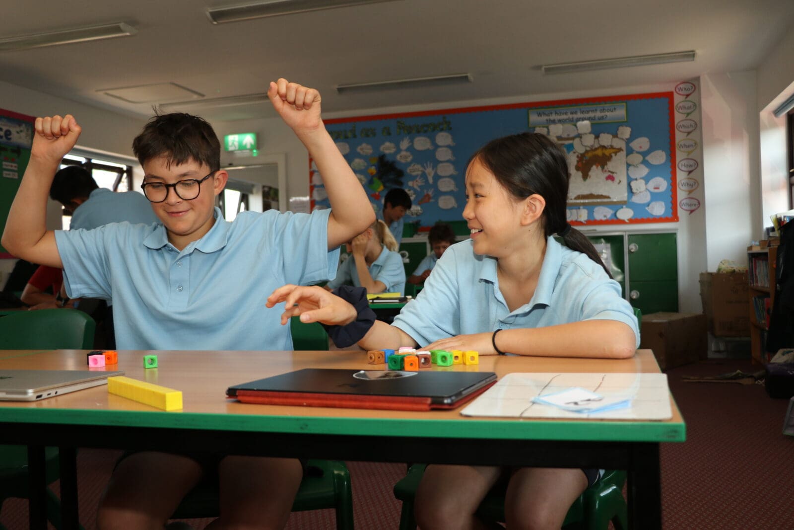 Boy and girl working together to solve maths puzzles