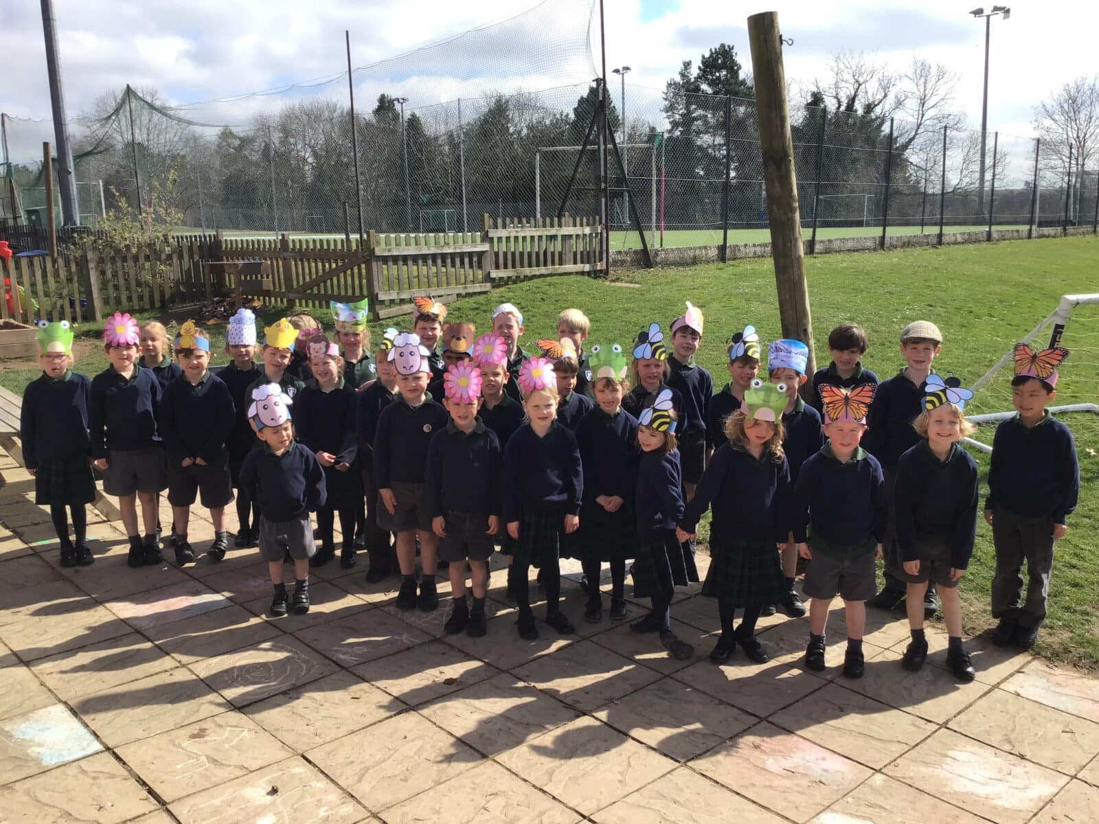 Children wearing colourful hats in the spring sunshine
