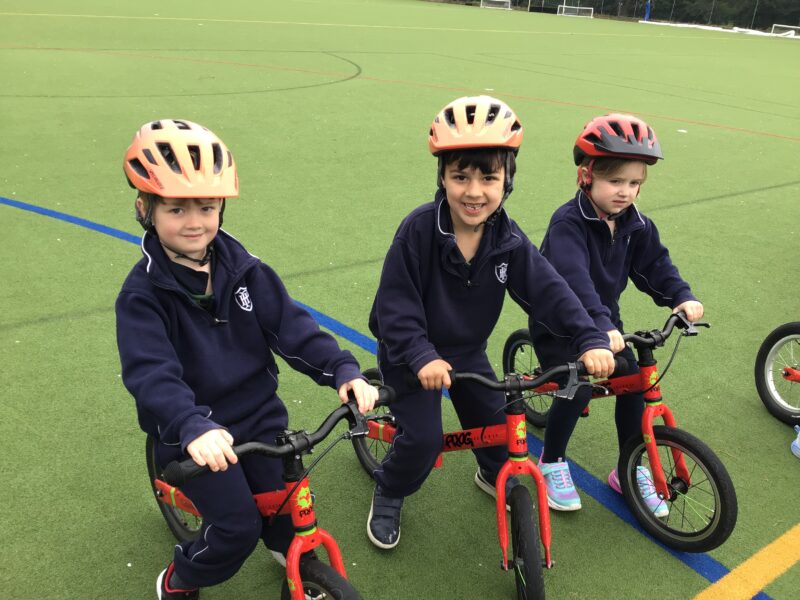 Three young boys on bikes with helmets