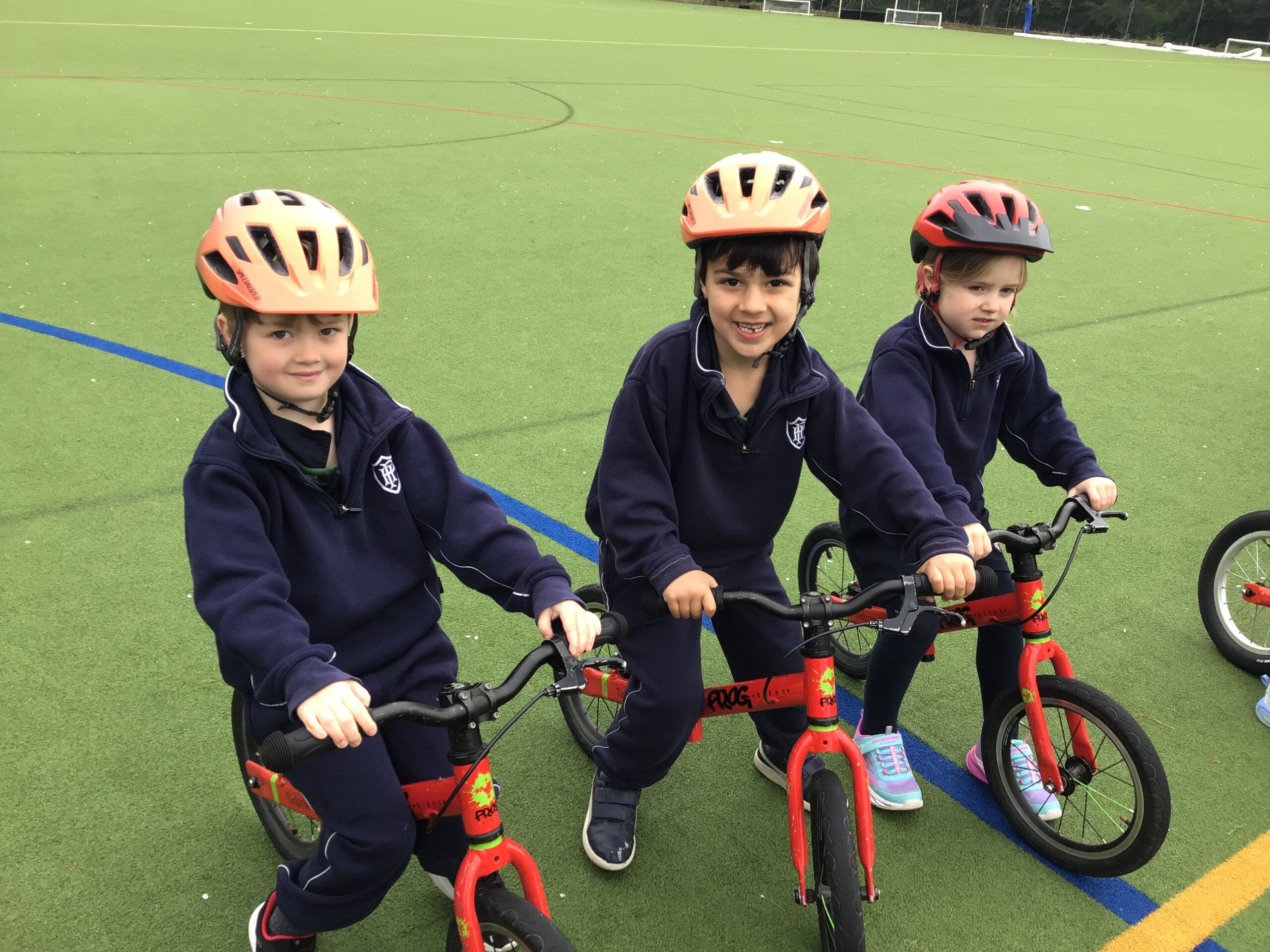 Three young boys on bikes with helmets