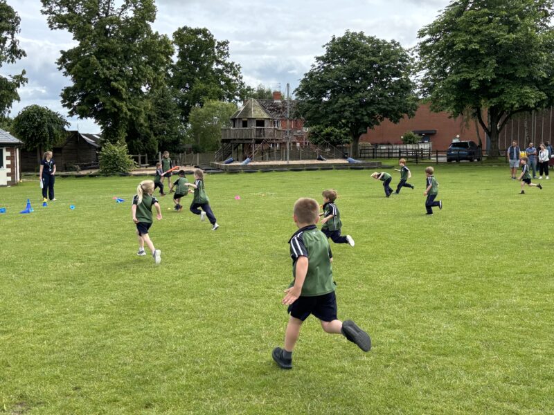 Young children playing cricket