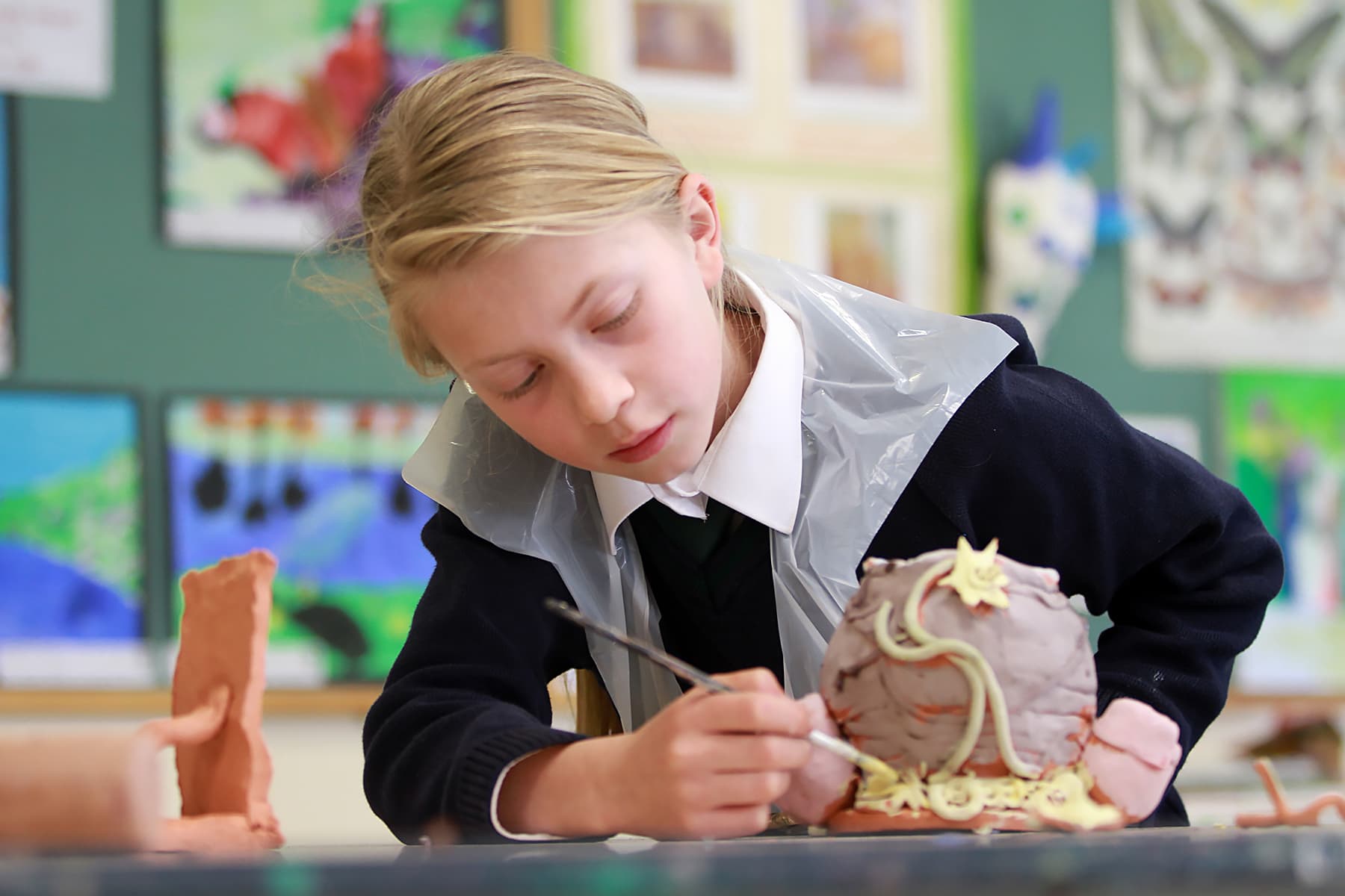 Art student creating clay sculpture