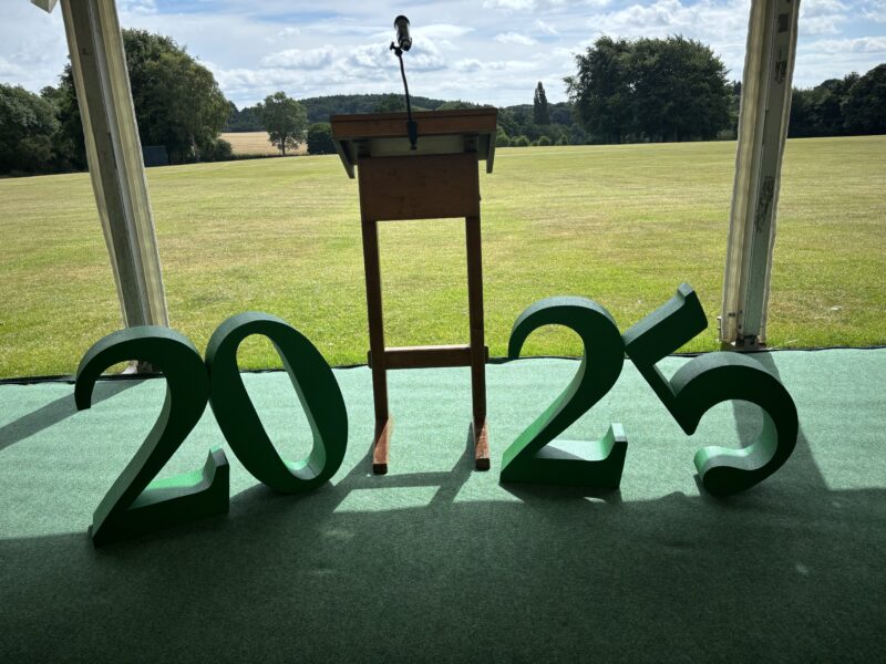 Picture of a 2025 sign and lectern