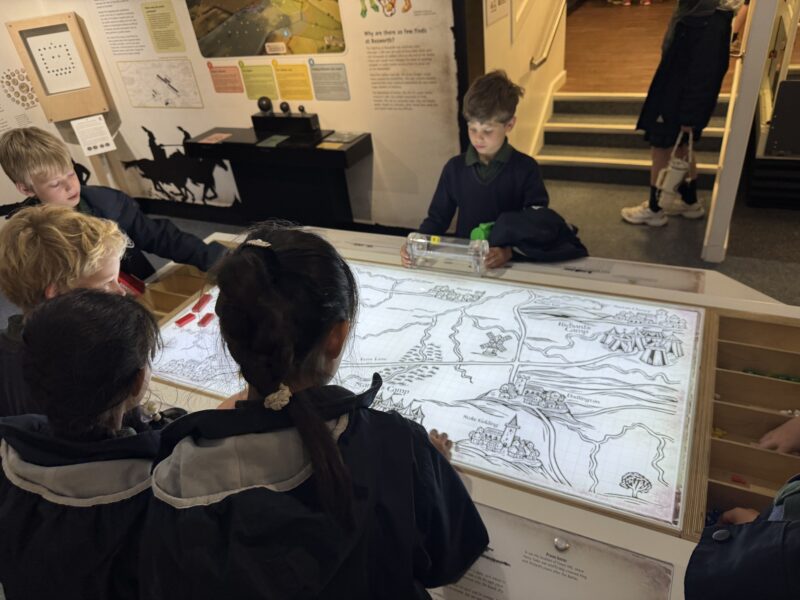 Children gathered round a historical map