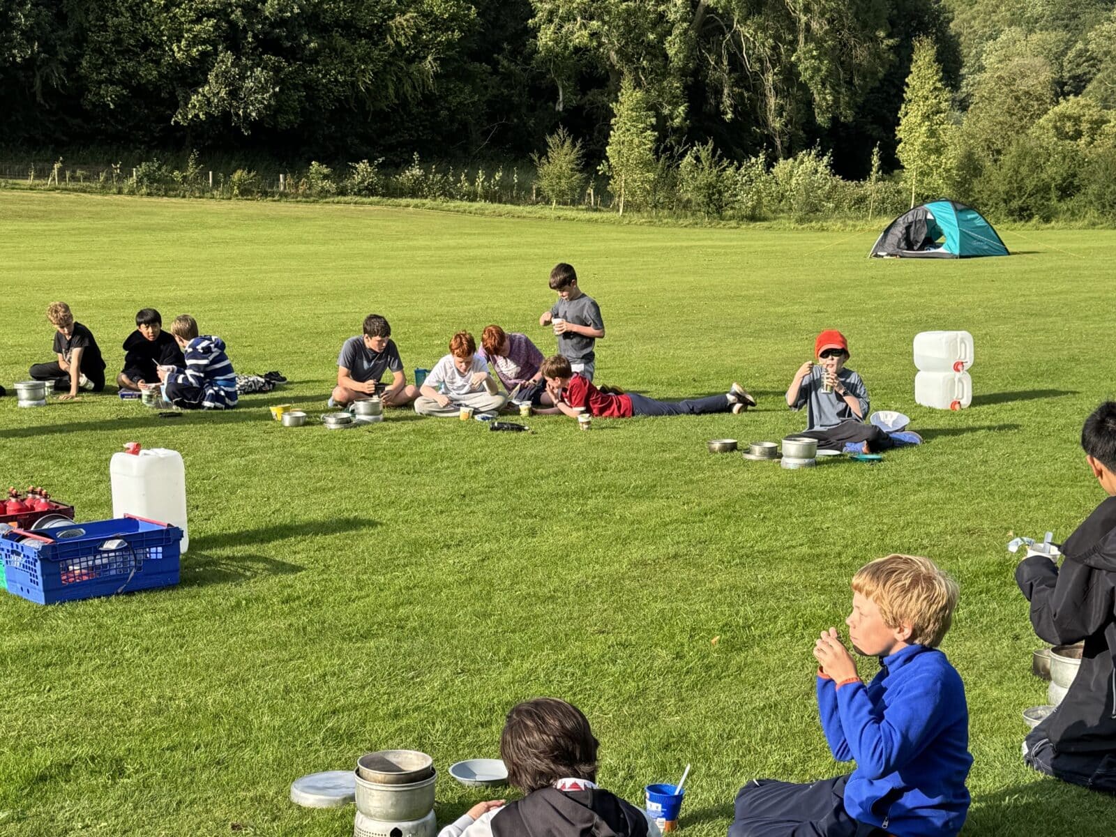 Group of children camping on school field