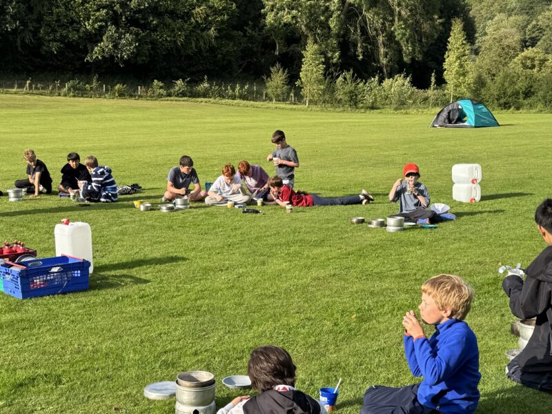 Group of children camping on school field