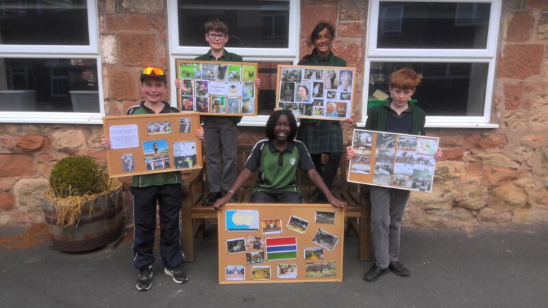 School children displaying their work on boards outside classroom