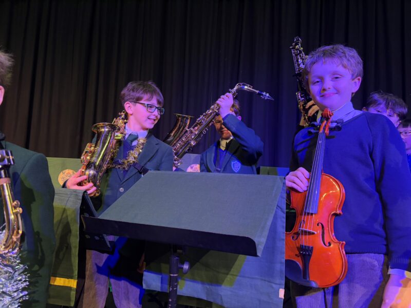 Children on stage with variety of musical instruments