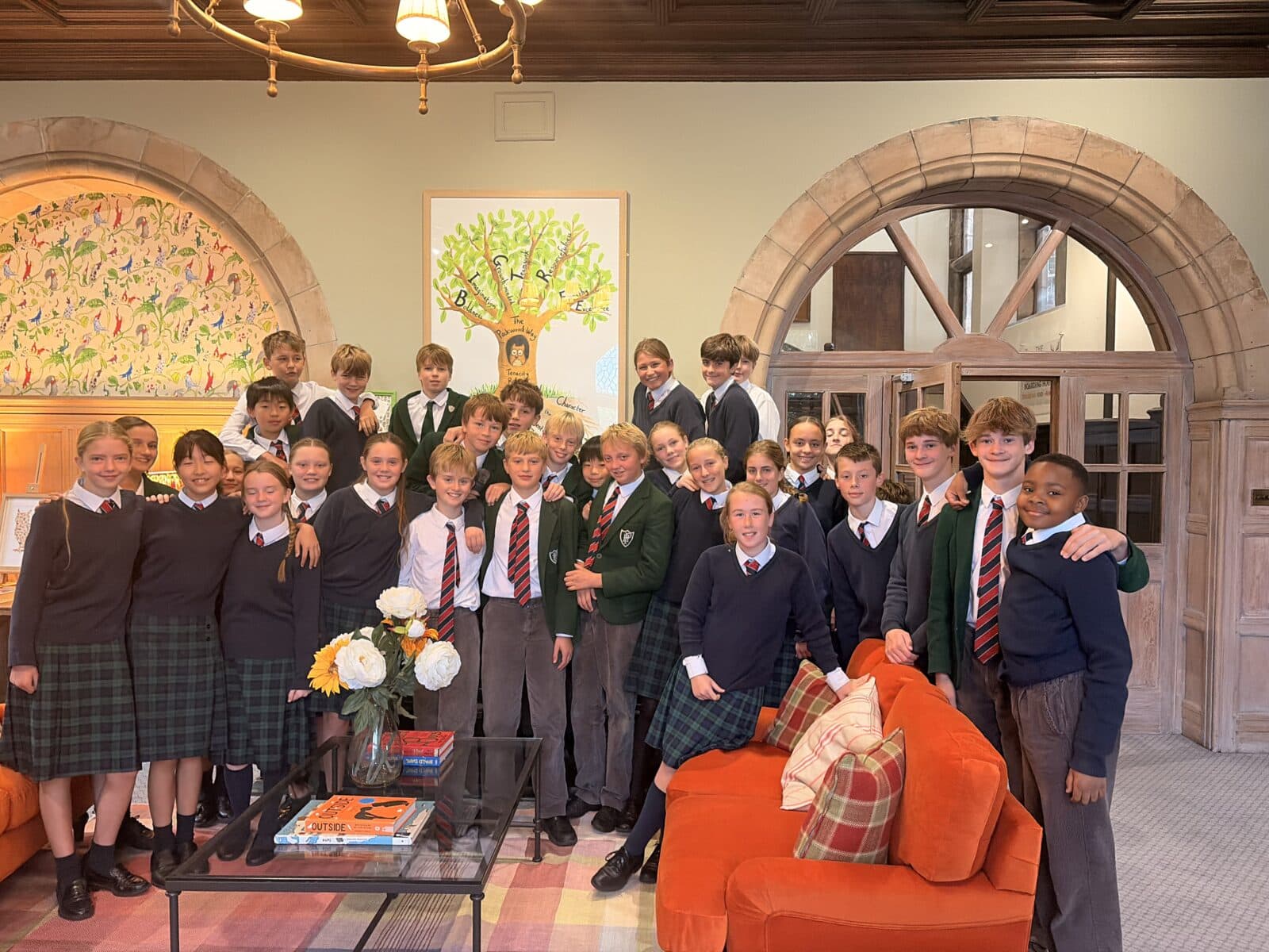 Group of happy school children in school hall