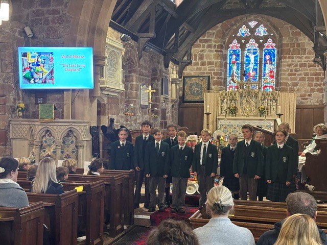 A beautiful village church with pupils singing