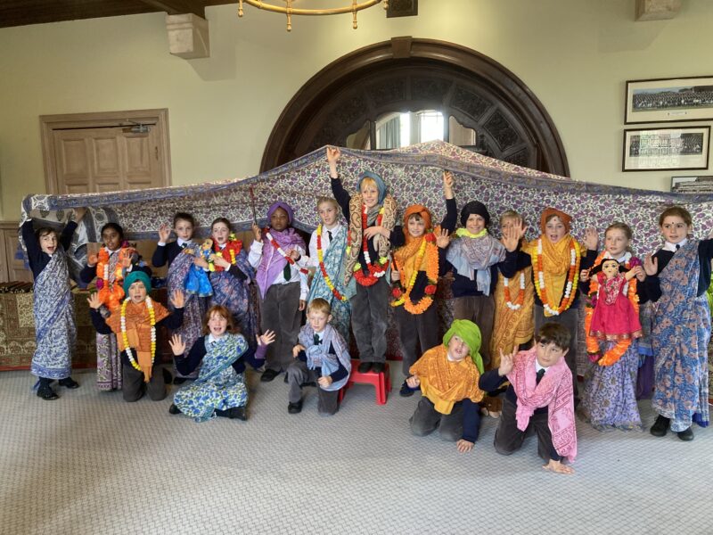 Large group of happy children, dressed in beautiful vibrant clothes