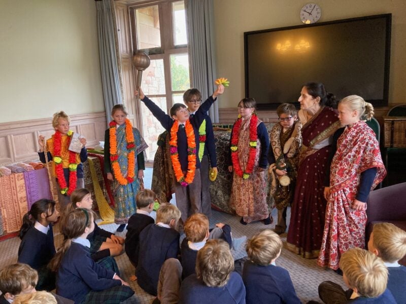 Group of school children learning about Hinduism