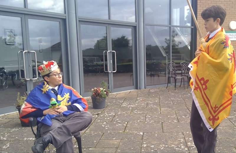 Two pupils doing a history re-enactment