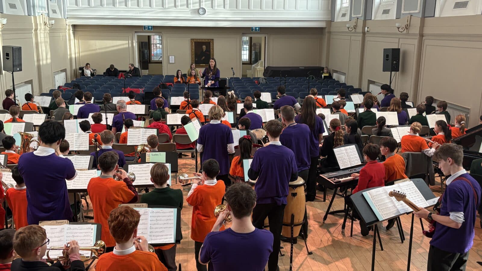 Group of school children playing musical instruments in a school concert