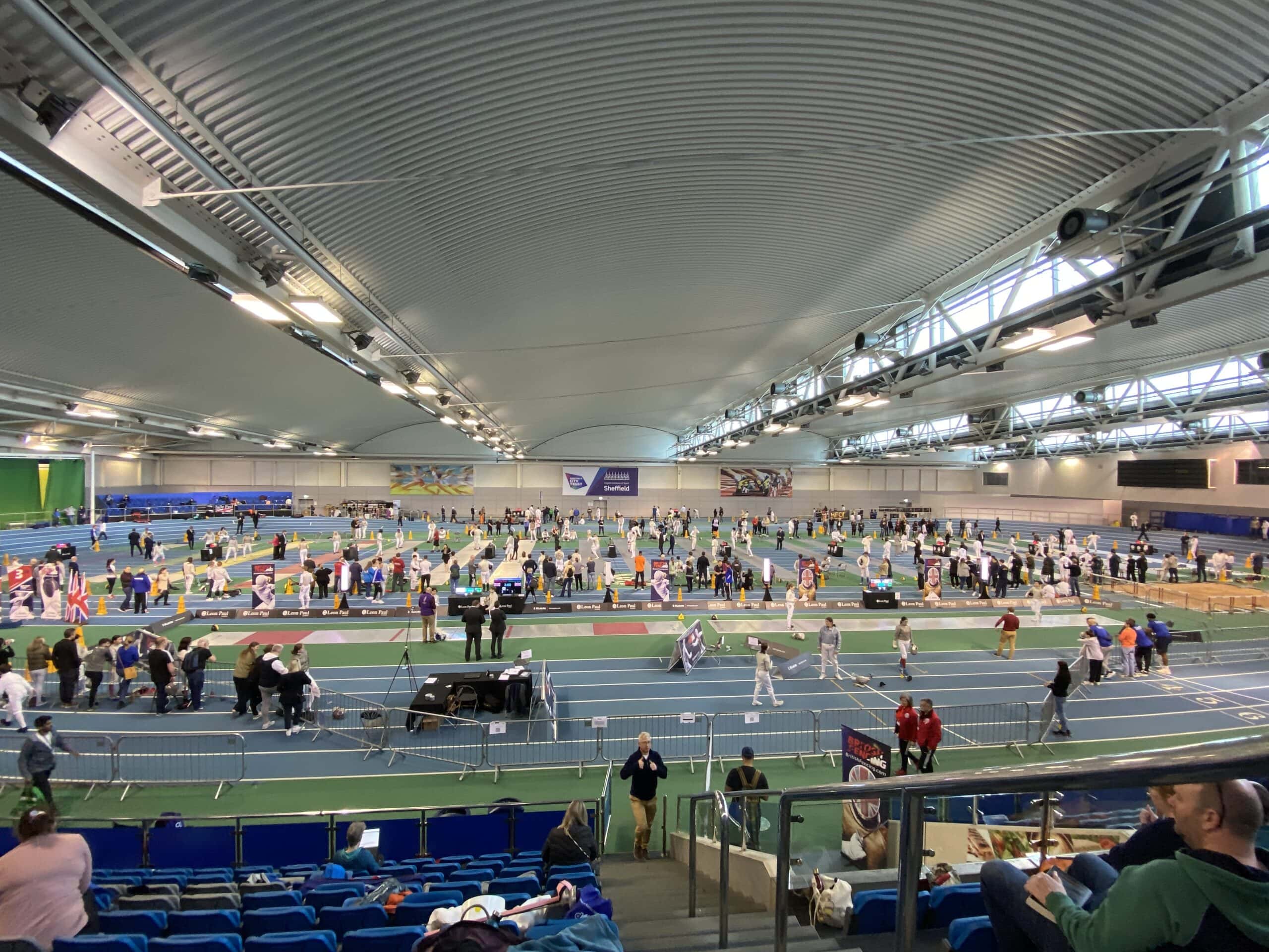 Busy indoor arena set up for national fencing competition