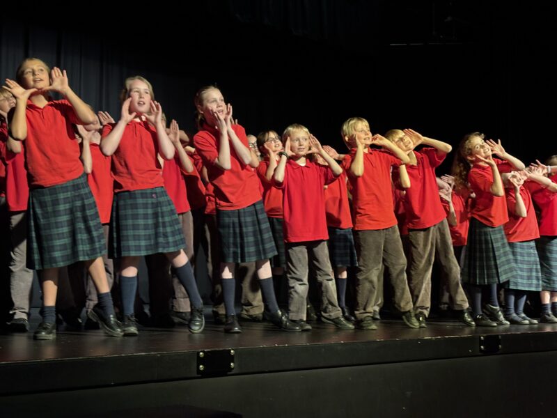 Group of children singing on stage