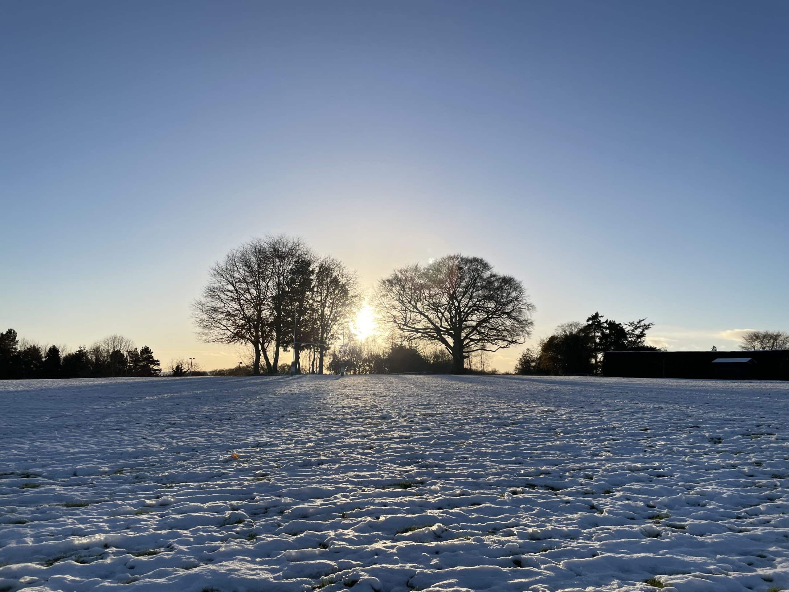 Snowy school grounds with sun setting