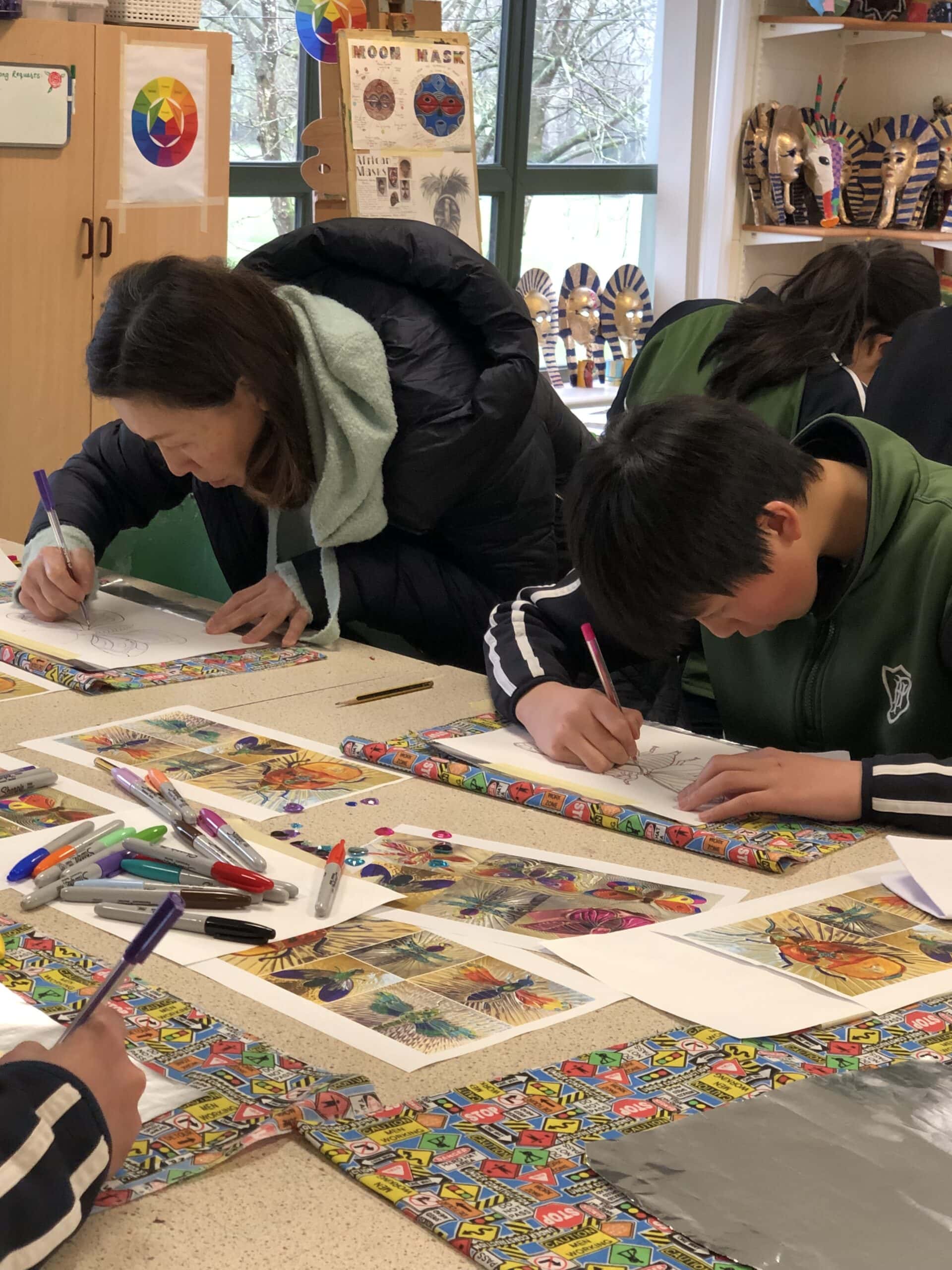 Mother and son painting in school Art classroom