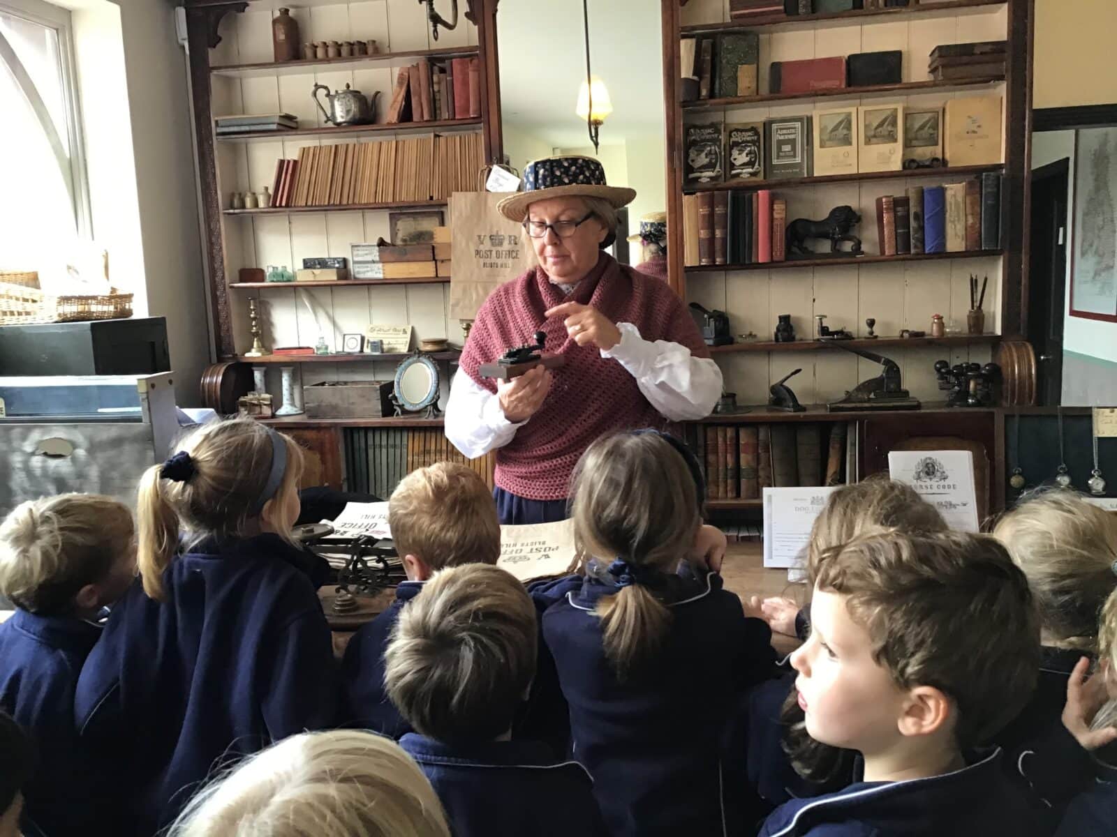 Group of school children visiting a shop in a Victorian town