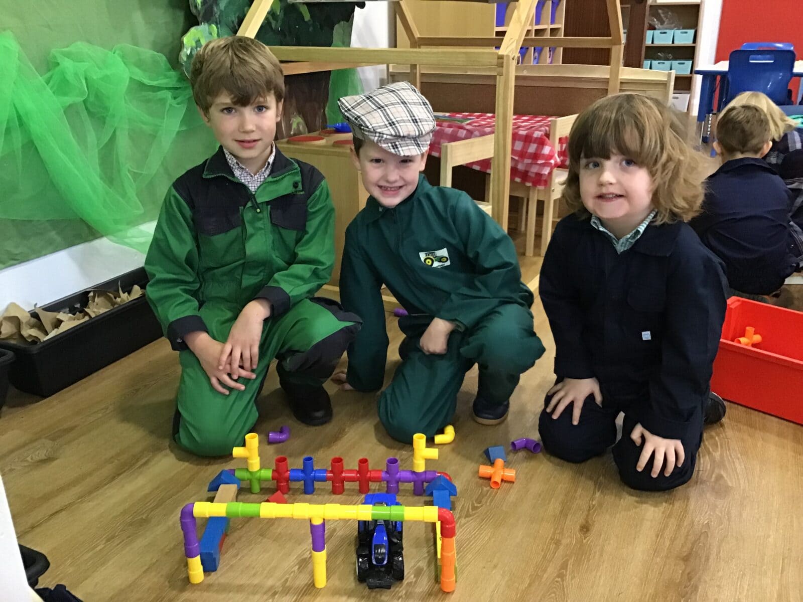 Three boys completing a puzzle in a classroom