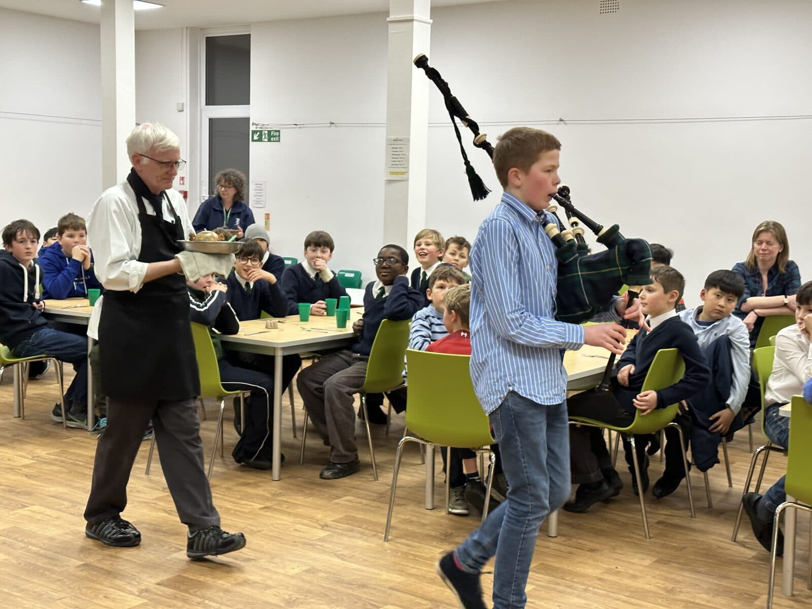 Children celebrating Burns Night and listening to bagpipes