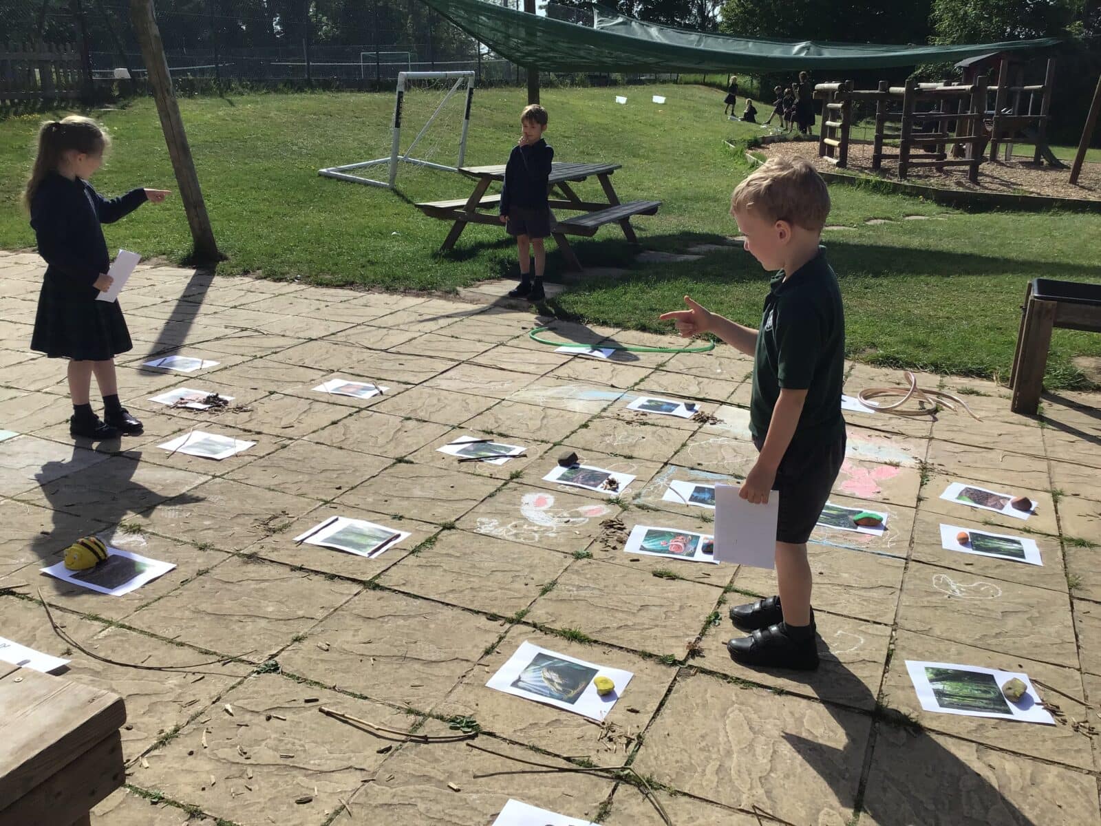 Children playing a game on a paved area with colourful diagrams