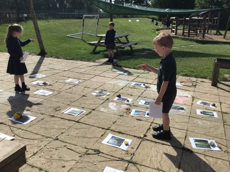 Children playing a game on a paved area with colourful diagrams