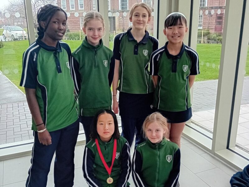 Six girls in Packwood tops in a theatre foyer