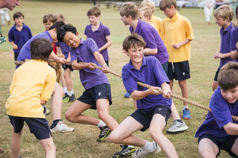 Children in a tug of war working as a team