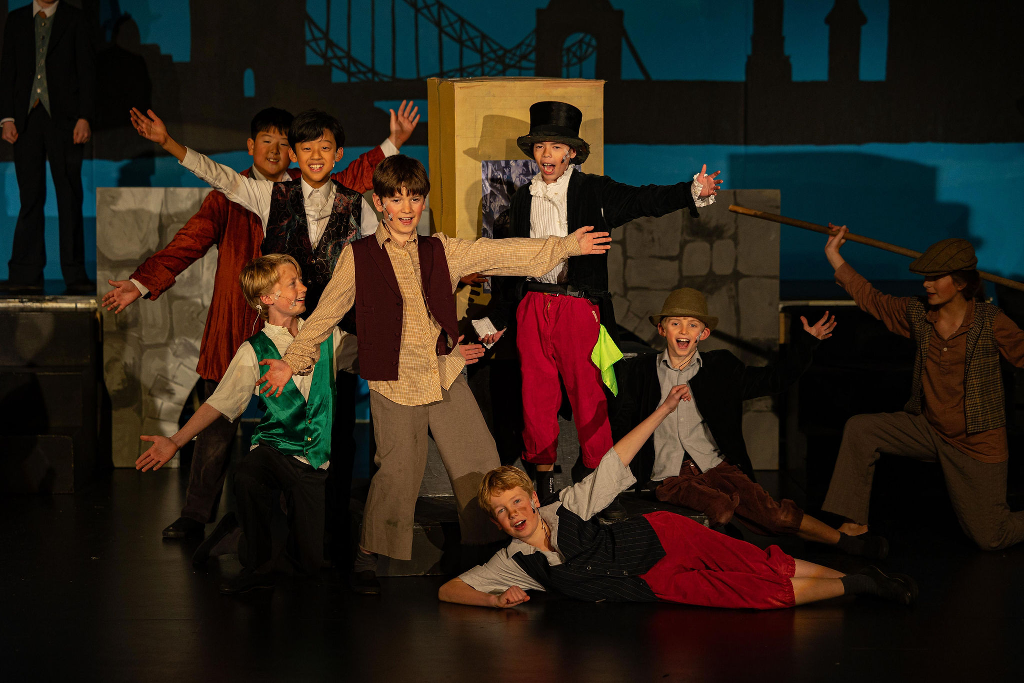 Group of school children performing a play in Victorian outfits