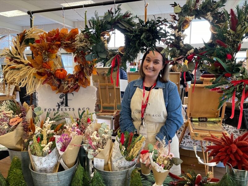Lady at a stall selling beautiful dried flowers and wreaths