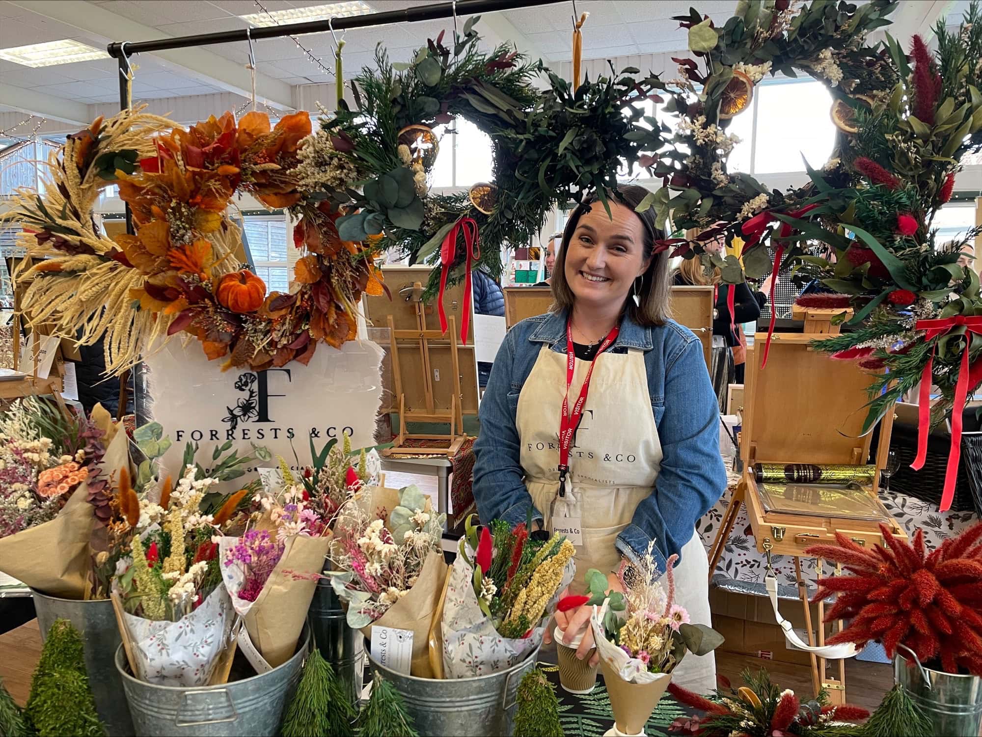 Lady at a stall selling beautiful dried flowers and wreaths