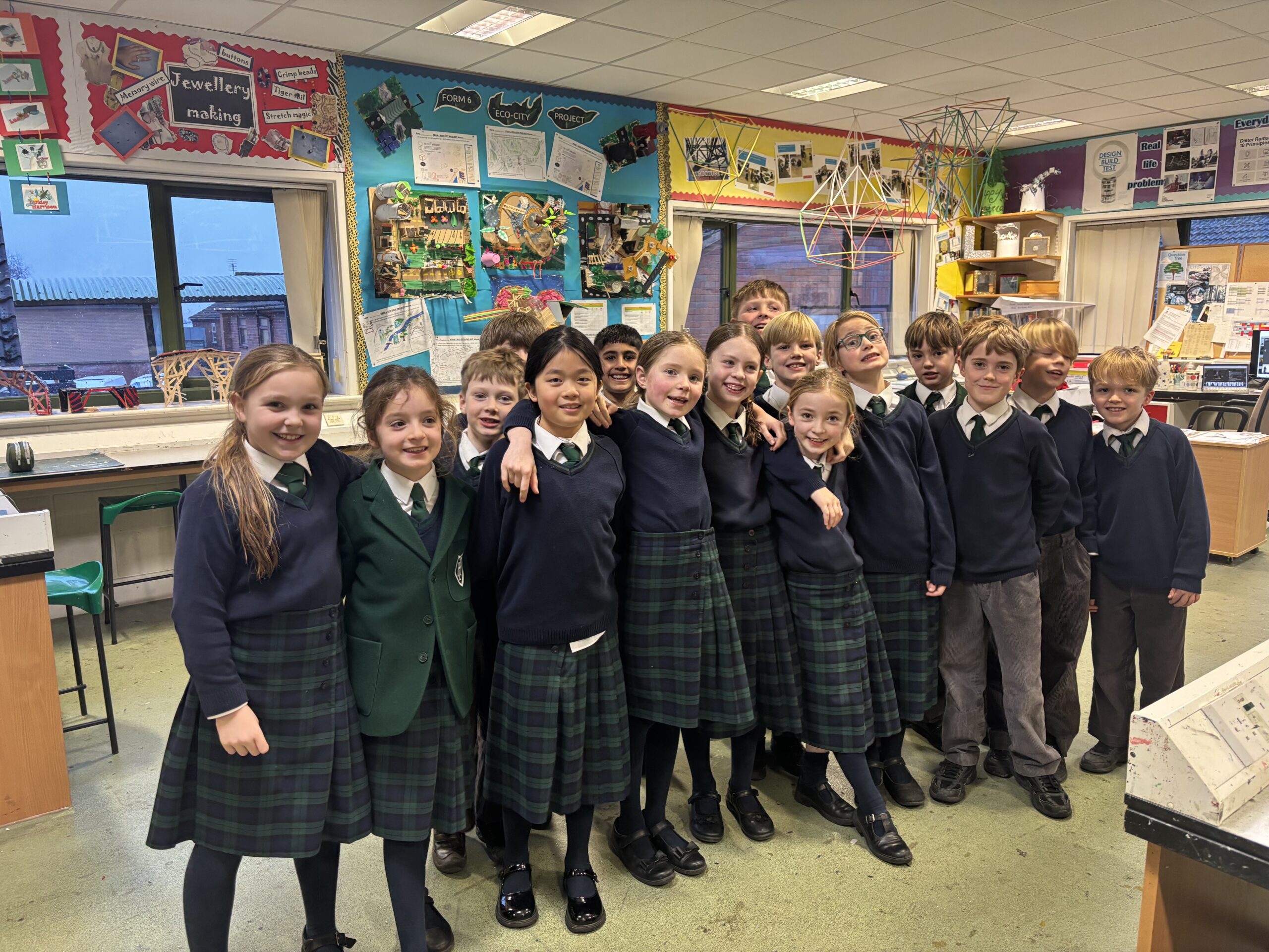 Group of happy school children in a design classroom