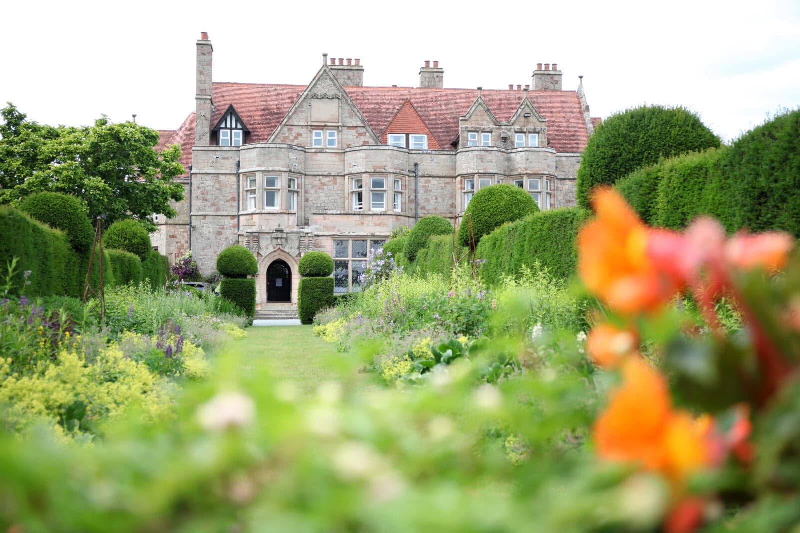 School building with beautiful garden and flowers in the foreground