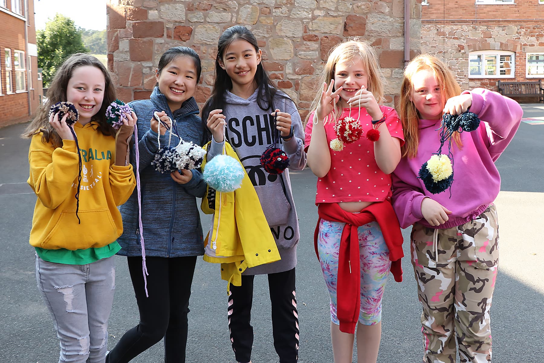 Girls with colourful pom-poms