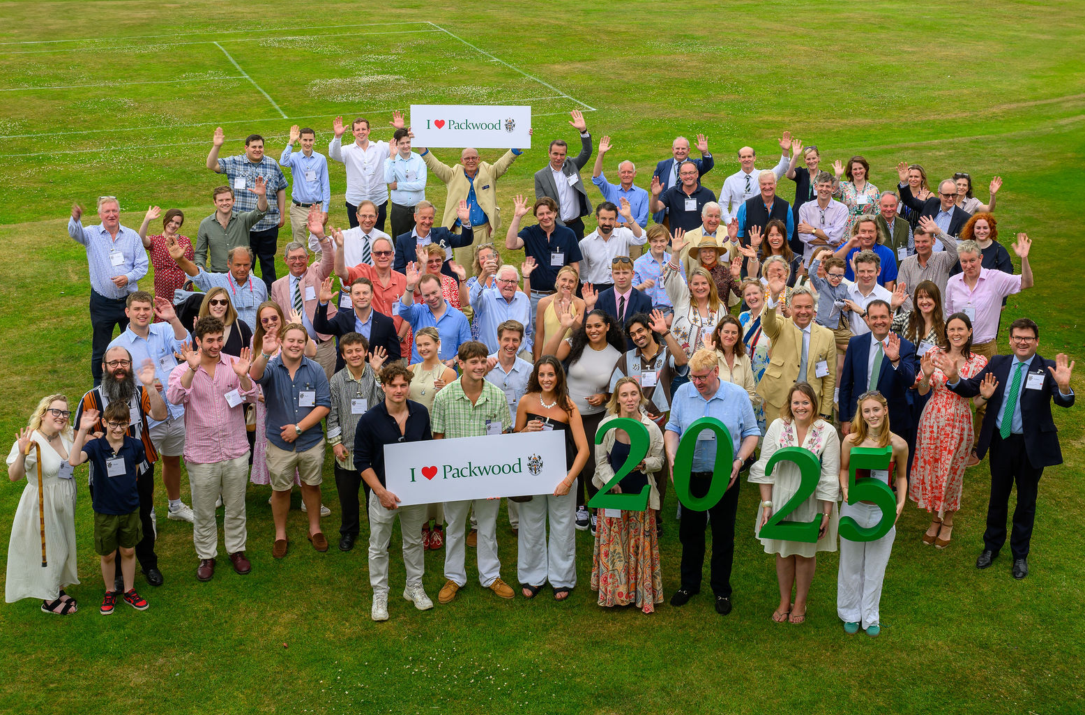 Group of people on lawn with I love Packwood sign