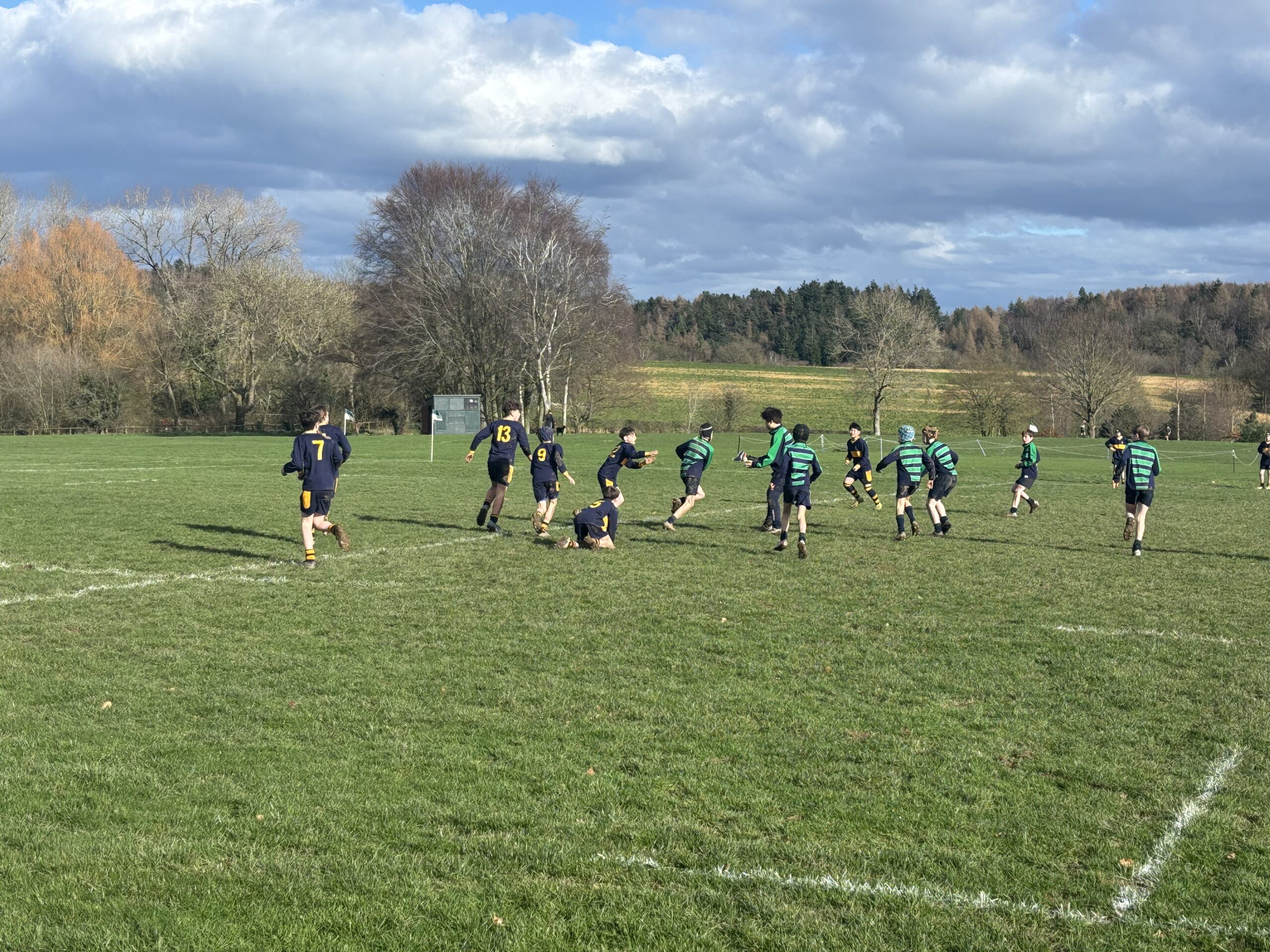 Children playing rugby on school playing field