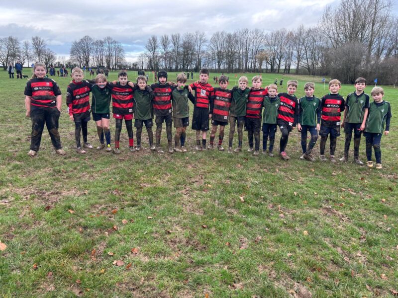 Two rugby teams in a muddy field