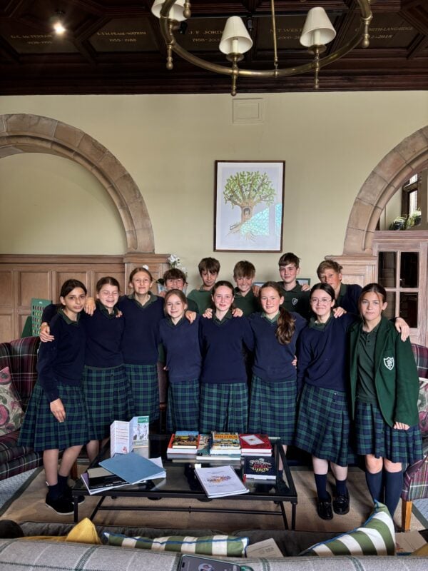 Group of children in school uniform gathered in entrance hall