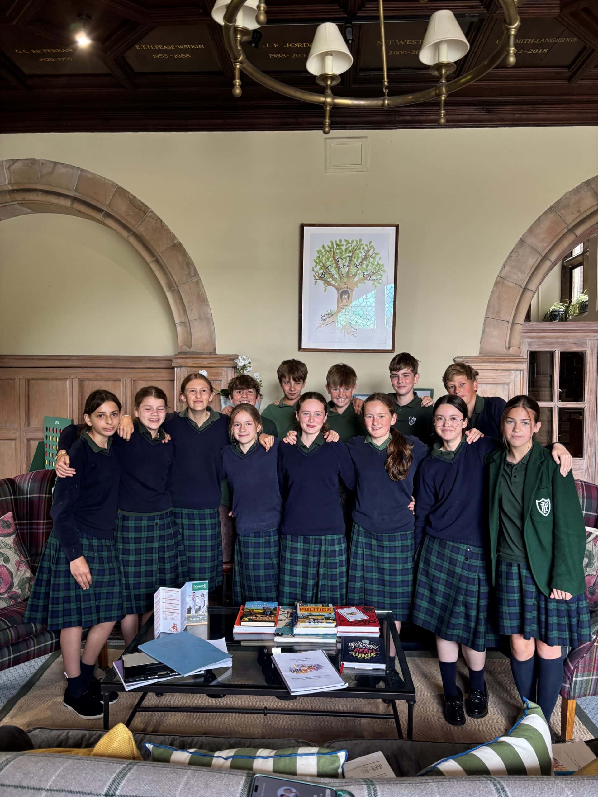Group of children in school uniform gathered in entrance hall