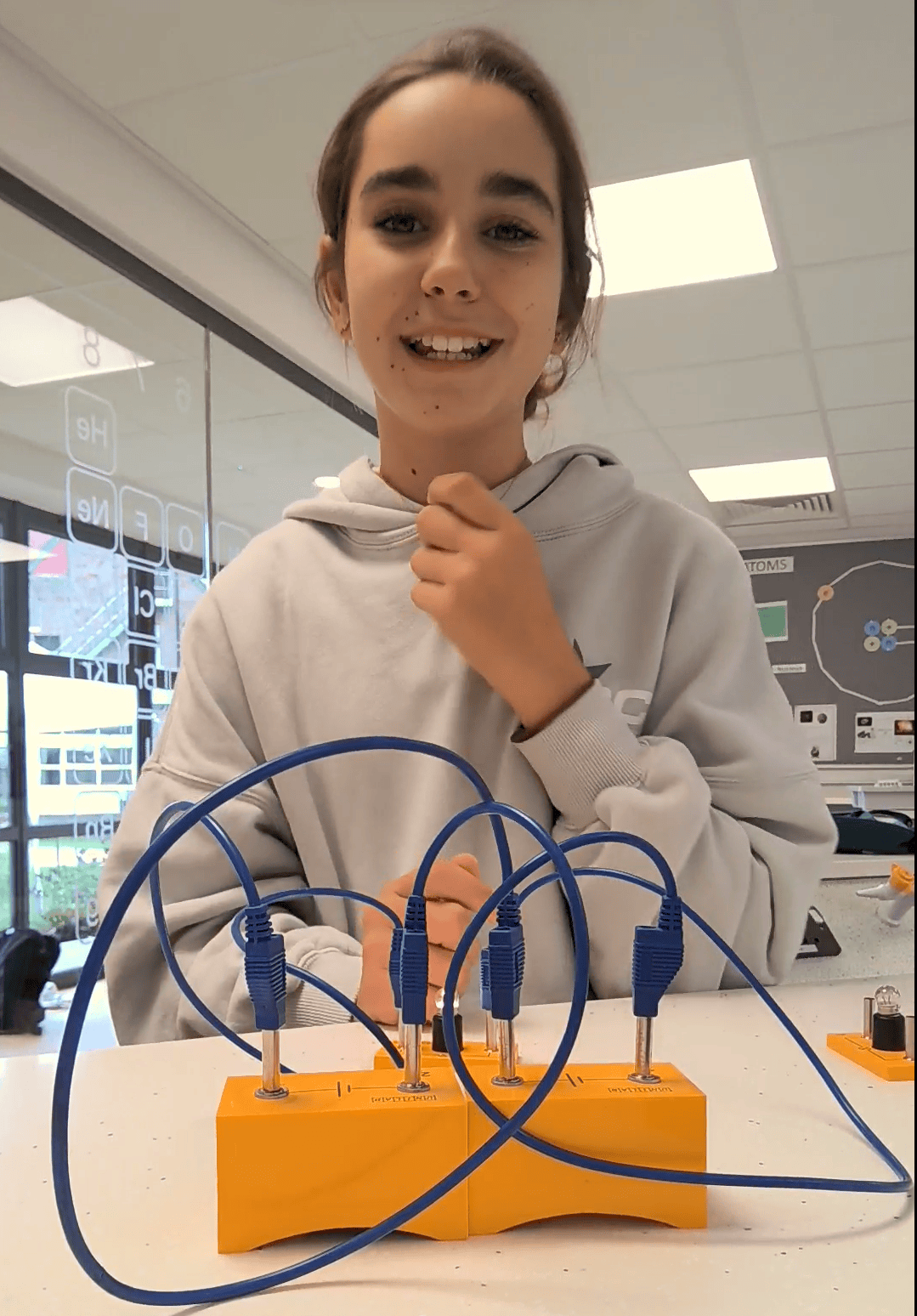 A young girl in a science lab carrying out an experiment