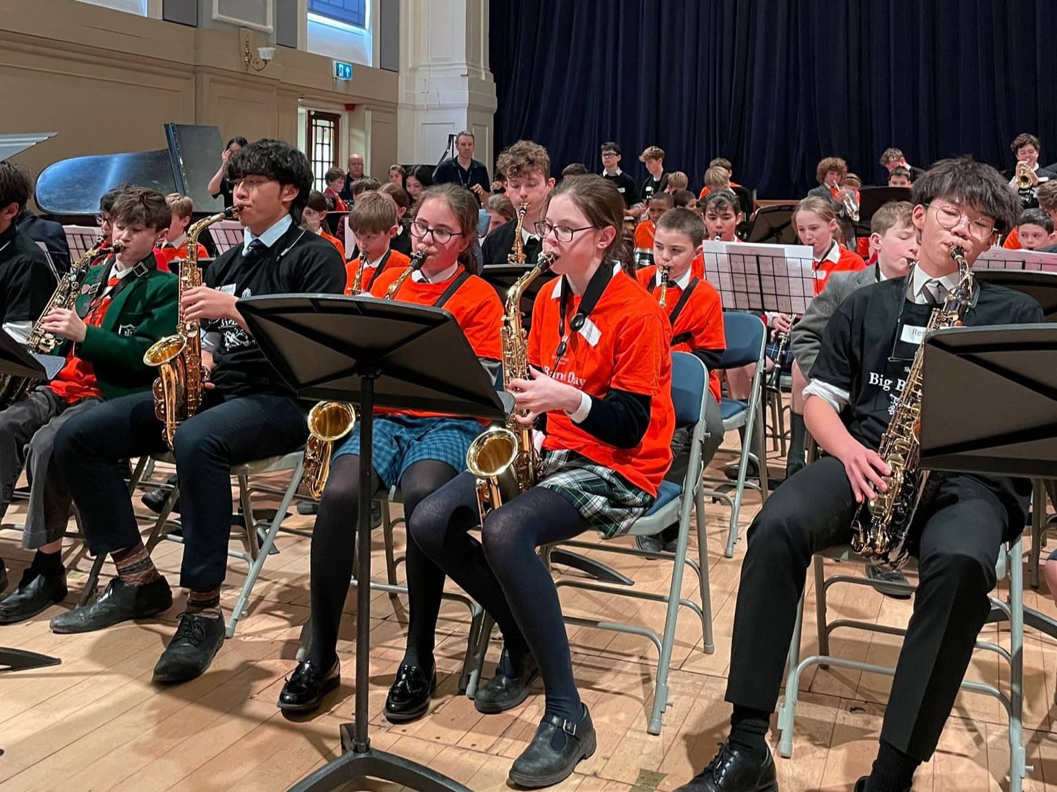 Group of children from a range of schools taking part in a big band concert