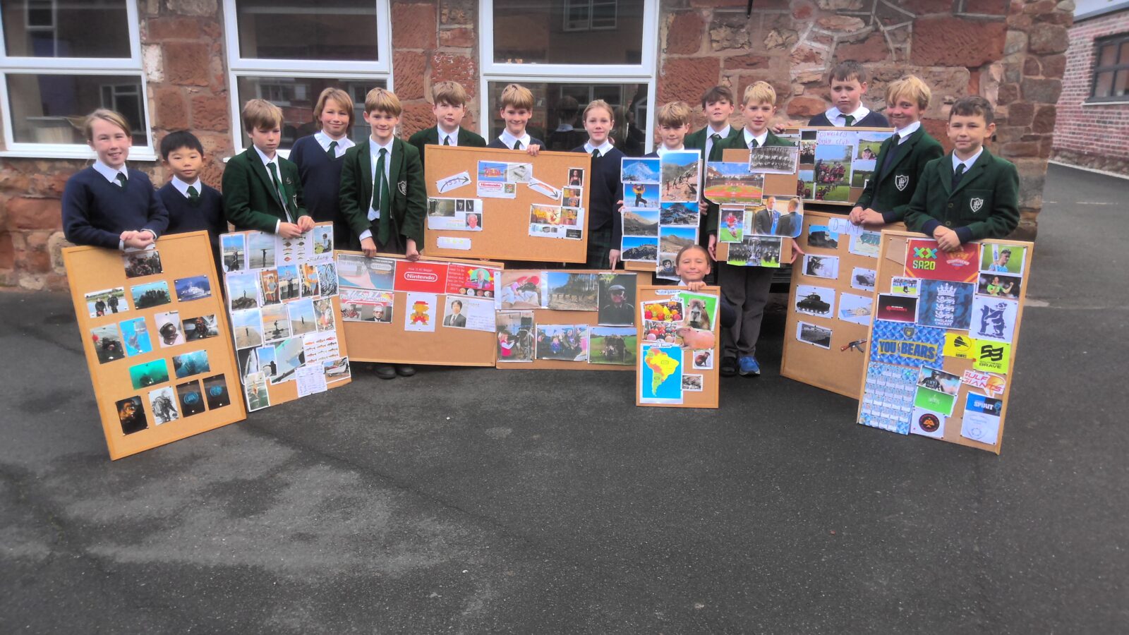 Children displaying boards of their schoolwork