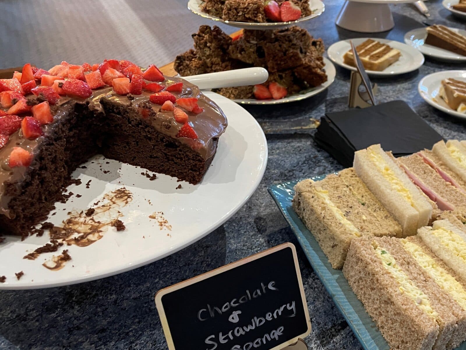 A selection of sandwiches and cakes